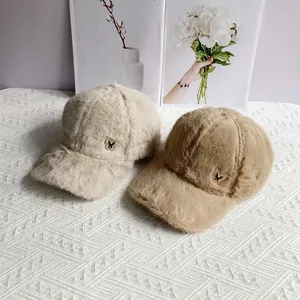 Detailed close-up of plush baseball caps with rhinestones butterfly emblems in soft tones