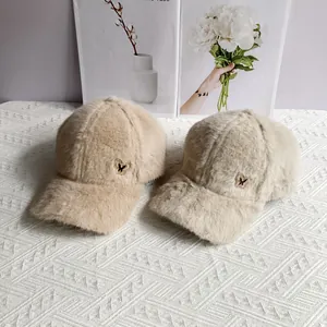 Detail view of plush warm winter baseball cap featuring crystal butterfly ornament detail