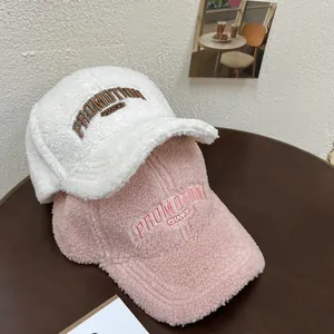 Close-up of plush teddy fleece baseball caps with detailed PROMOTION letter embroidery