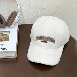Close-up of white fleece baseball cap featuring brown Promotion Chance embroidery detail