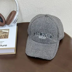 Close-up of grey teddy fleece baseball cap with black PROMOTION CHANCE embroidery