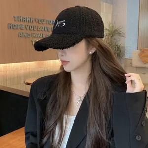 Close-up of black fleece baseball cap featuring white Balance embroidery detail
