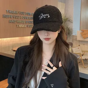 Close-up of black fleece baseball cap with white Balance cursive embroidery detail