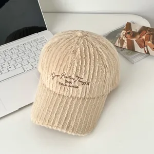Close-up of beige plush baseball cap with embroidered text on a soft lifestyle background