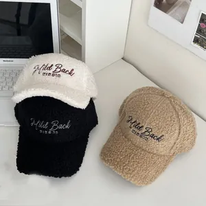 Macro detail of plush sherpa baseball caps with high-density Wild Back WINTER embroidery