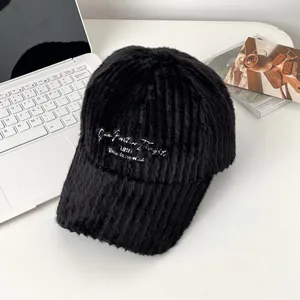 Close-up of black plush baseball cap featuring white 'Born to be Wild' embroidery detail