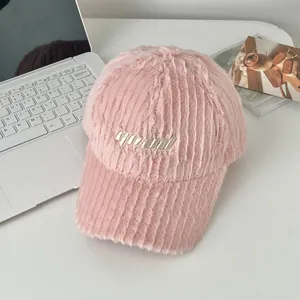 Detail of pink plush baseball cap with embroidered GOOD letters and soft striped texture