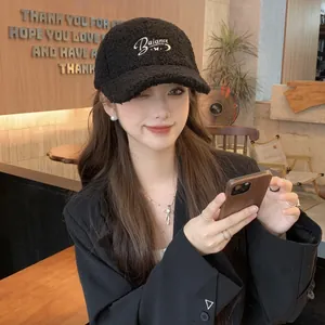 Detail of white Balance embroidery on black lamb wool baseball cap for women