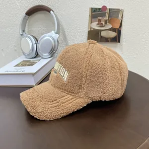 Detailed view of camel faux fur baseball cap with white MOTION 3D embroidery on wooden table