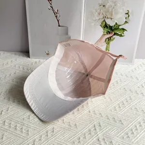 Internal view of pink denim baseball cap with 100% polyester label and shape support
