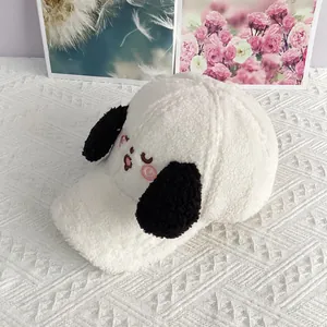 Detail of cute embroidered puppy face on plush white lamb fleece baseball cap