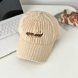 Detail of plush beige baseball cap featuring GOOD FRIENDS embroidery and fuzzy ribbed texture