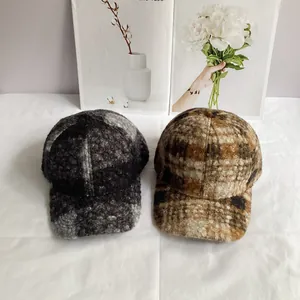 Detailed texture of thick plaid teddy fleece baseball caps in black and brown colors