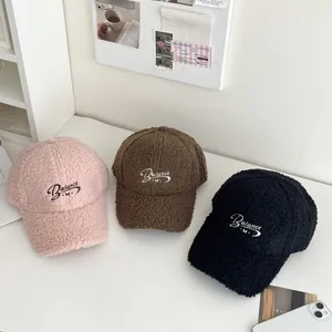 Three warm fleece baseball caps in pink, brown and black with Balance embroidery