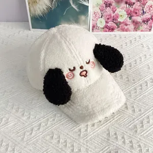 Close-up of white plush baseball cap with embroidered dog face and black 3D ears