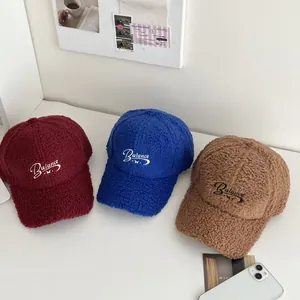 Three lamb wool baseball caps in burgundy, blue, and brown with Balance embroidery