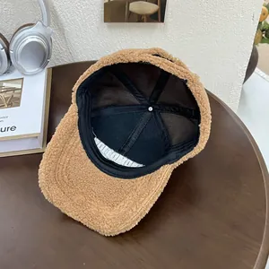 Detailed view of plush teddy fabric winter baseball cap with internal outdoor brand label