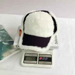 Detailed view of lightweight winter plush baseball cap on a scale weighing 138g