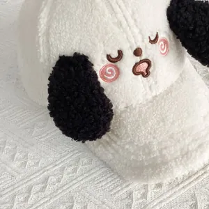 Close-up of fluffy plush baseball cap with embroidered puppy face and black floppy ears