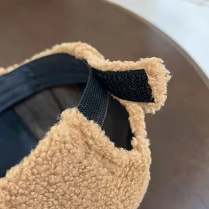 Close-up of adjustable elastic Velcro strap on brown plush faux fur baseball cap