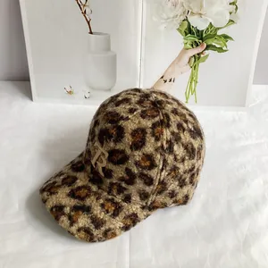 Detailed view of leopard print faux fur baseball cap featuring beige TB embroidered logo
