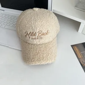 Detailed view of beige lamb wool baseball cap with embroidered Mild Back WINTER text