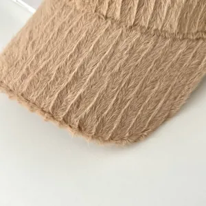Detailed macro view of the light brown plush fabric with soft vertical ribbed texture