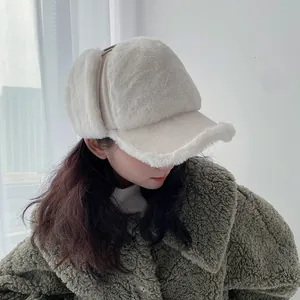 Close-up of white plush earflaps and fabric texture on a winter trapper hat