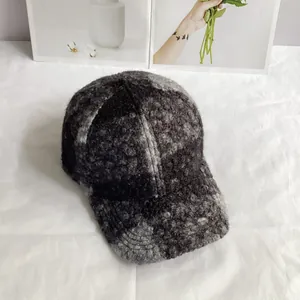 Close-up of thick grey and black teddy fleece texture on this warm winter baseball cap