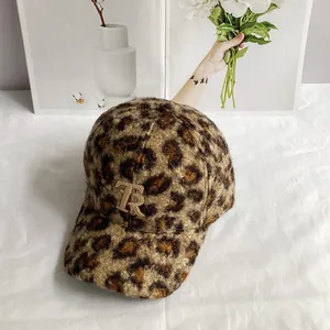 Macro view of leopard print plush baseball cap texture with metallic TR logo