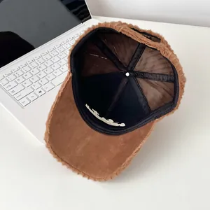 Detail of plush baseball cap showing soft faux fur lining and reinforced inner stitching