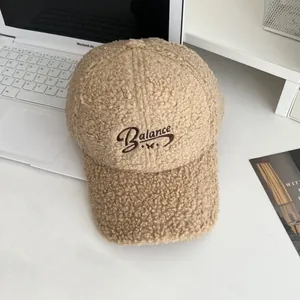 Detailed view of khaki sherpa fleece baseball cap with Balance embroidery and butterfly