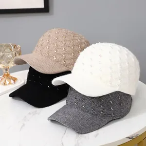 Close-up of knit baseball caps with rhinestone details in khaki, black, white and grey