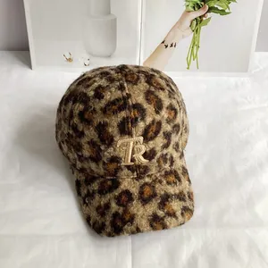 Detailed close-up of leopard print teddy fleece texture and gold TR embroidery on cap