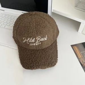 Detailed close-up of brown sherpa baseball cap featuring Mild Back WINTER white embroidery