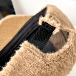Detail of adjustable Velcro strap on khaki faux fur baseball cap with plush texture