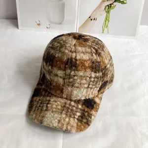Detailed view of autumn winter plaid baseball cap in warm brown tweed texture