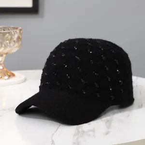 Minimalist black knit baseball cap with sparkling rhinestones for winter warmth