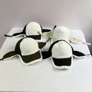 Detail view of winter earflap baseball caps in four colors with thick white faux fur lining