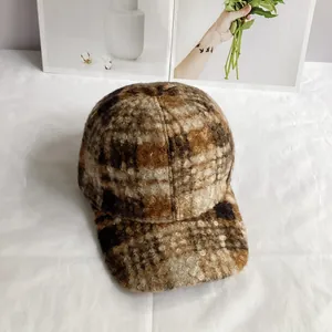 Detail of warm teddy velvet baseball cap featuring a vintage brown plaid pattern