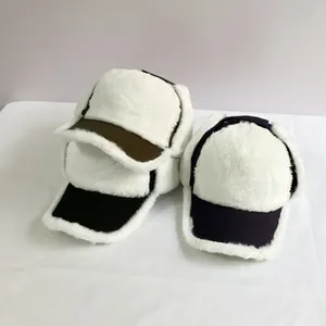 Three winter earflap hats with white faux fur lining in army green, black, and deep purple