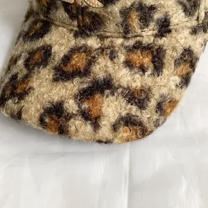 Close-up of leopard print baseball cap featuring thick faux shearling fleece texture