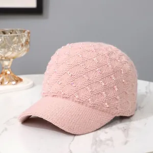Detail of pink knitted baseball cap with diamond studs and elegant quilted texture