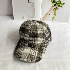 Close-up of the woven plaid texture and thick teddy velvet fabric on a baseball cap