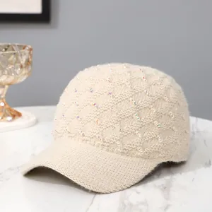 Elegant beige knit baseball cap with colorful sequins on soft faux fur texture