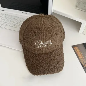 Detailed texture of brown fleece baseball cap with white Balance embroidery on white table