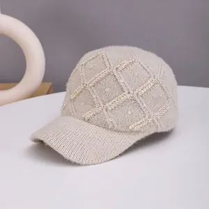 Close-up of oatmeal knit baseball cap featuring sparkling rhinestones and sequins