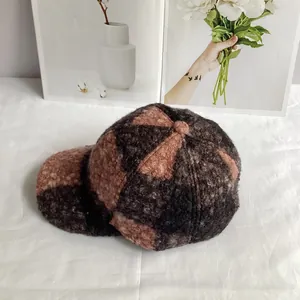 Detail of color-block teddy fleece baseball cap with soft grainy texture and warm fabric