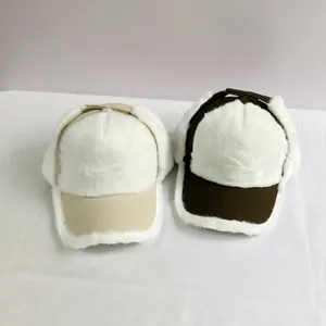 Detail of windproof ear-flap baseball caps in beige and olive with white faux fur lining