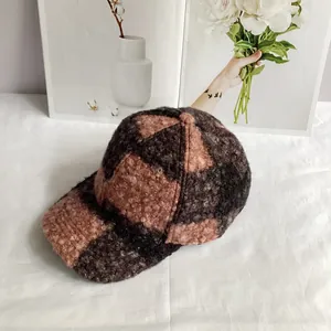 Detail of checkered teddy fleece texture on the warm patchwork baseball cap